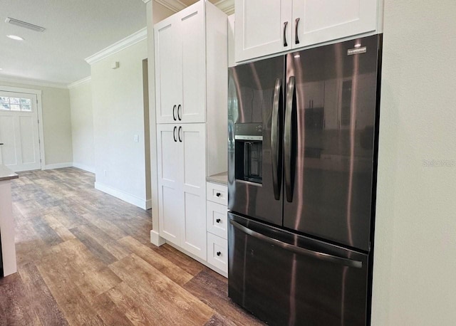 kitchen featuring stainless steel refrigerator with ice dispenser, crown molding, light hardwood / wood-style flooring, and white cabinets