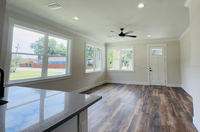 interior space with ceiling fan, ornamental molding, and dark hardwood / wood-style flooring