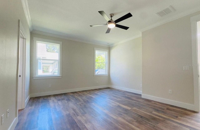 empty room featuring dark hardwood / wood-style flooring, ornamental molding, and ceiling fan