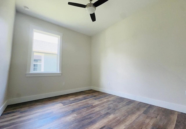 empty room featuring ceiling fan and dark hardwood / wood-style floors