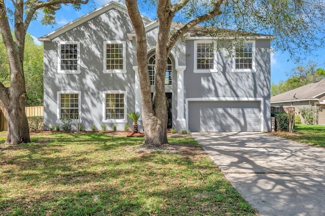 view of property with a front lawn and a garage