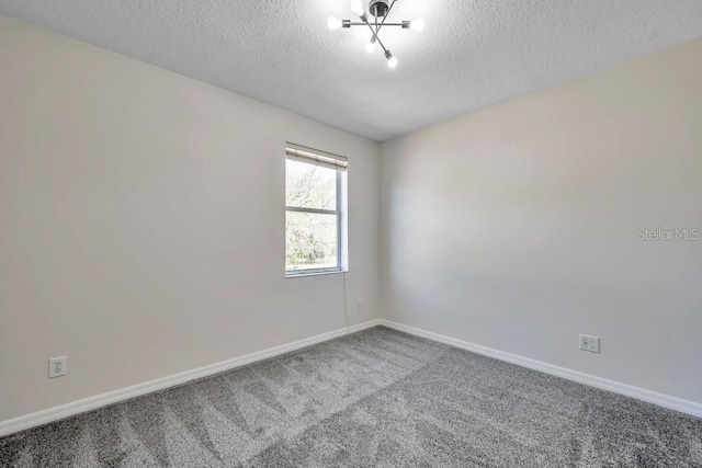 unfurnished room featuring carpet floors and a textured ceiling