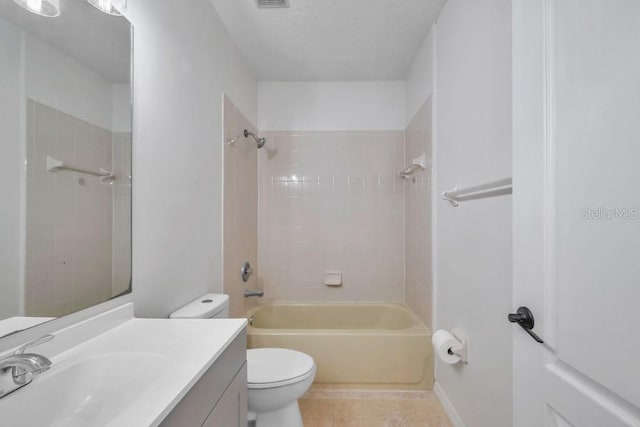 full bathroom with toilet, tiled shower / bath, tile patterned flooring, and vanity