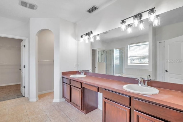 bathroom with tile patterned flooring, vanity, and shower with separate bathtub