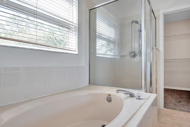 bathroom featuring tile patterned flooring and independent shower and bath