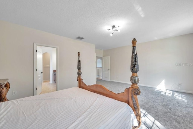 carpeted bedroom with a textured ceiling