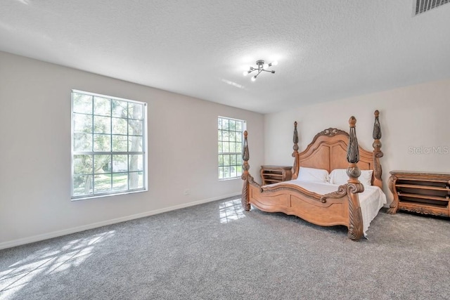 carpeted bedroom featuring a textured ceiling