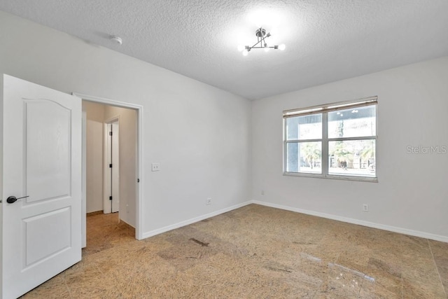 spare room with a textured ceiling