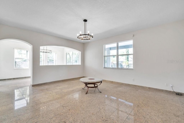 spare room featuring a notable chandelier