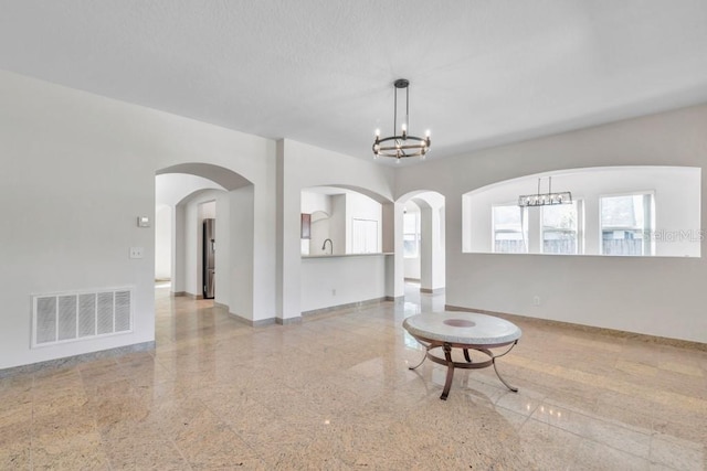 living room featuring sink and a chandelier