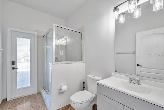 bathroom with toilet, walk in shower, and vanity