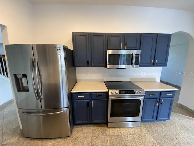 kitchen featuring appliances with stainless steel finishes and blue cabinets