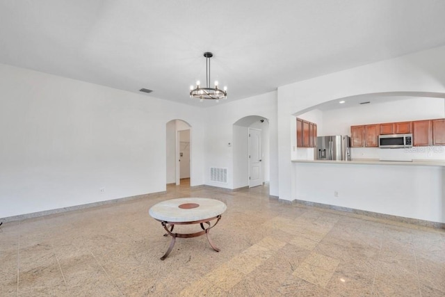 unfurnished living room with a chandelier