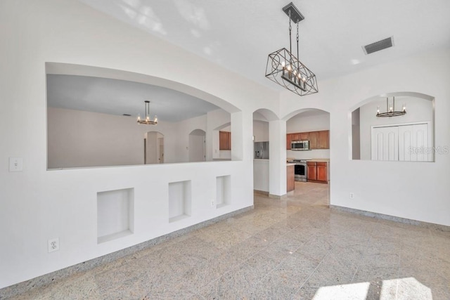 unfurnished room with a chandelier