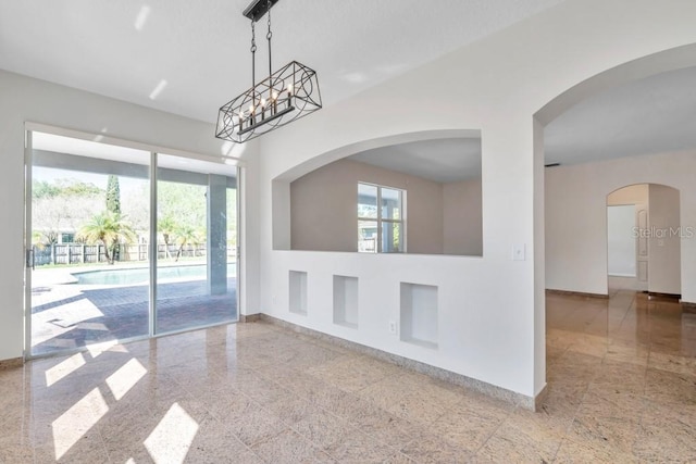 unfurnished room featuring plenty of natural light