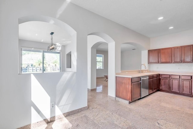 kitchen featuring sink, dishwasher, plenty of natural light, and decorative light fixtures