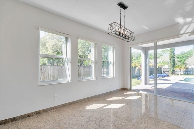 interior space with plenty of natural light and a notable chandelier