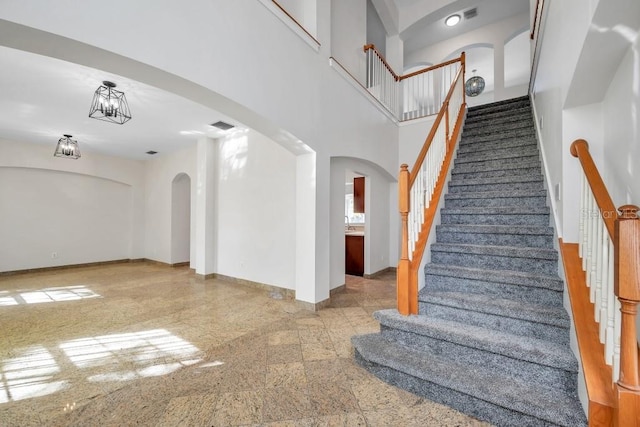 staircase featuring a high ceiling