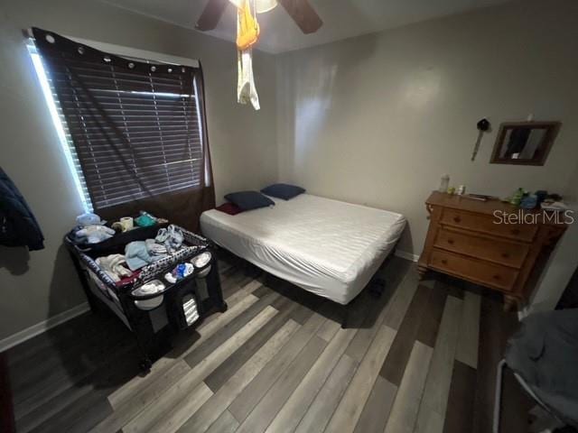 bedroom featuring hardwood / wood-style flooring and ceiling fan