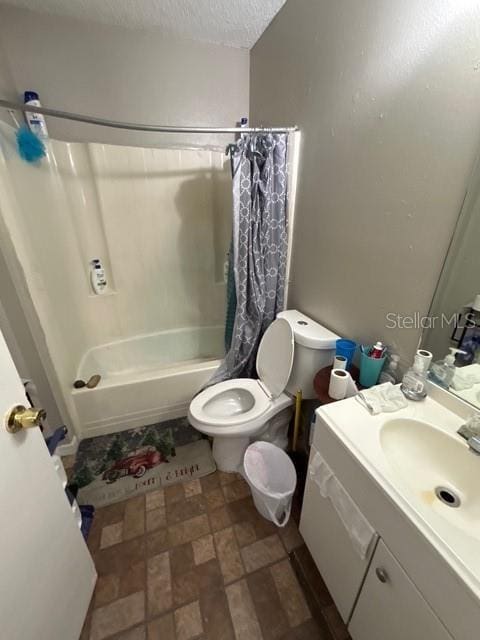 full bathroom with vanity, shower / tub combo, a textured ceiling, and toilet