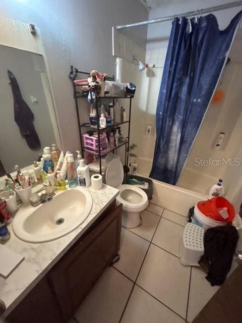 full bathroom featuring vanity, tile patterned floors, shower / bath combination with curtain, and toilet