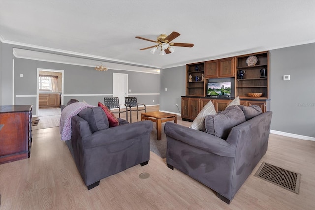 living room with light hardwood / wood-style flooring, ceiling fan, and ornamental molding