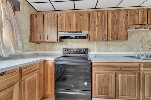 kitchen with sink, a paneled ceiling, and electric range