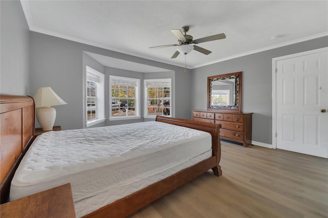 bedroom with ceiling fan, light hardwood / wood-style flooring, and crown molding