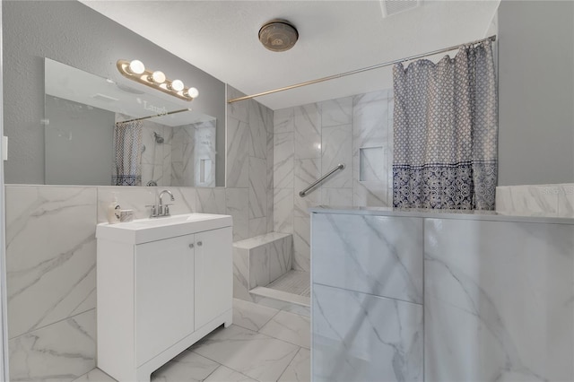 bathroom with a textured ceiling, vanity, and a shower with curtain