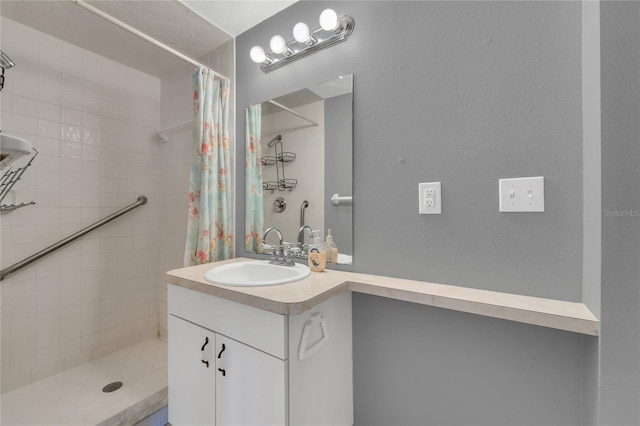 bathroom featuring walk in shower and vanity