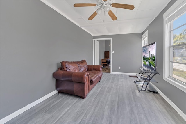 living area with ceiling fan and hardwood / wood-style floors