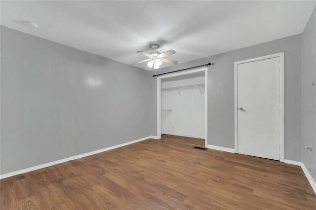 unfurnished bedroom with ceiling fan and wood-type flooring