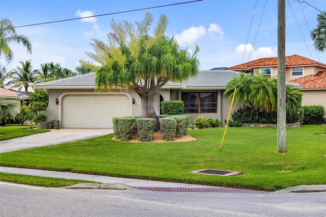 view of front of home with a front yard and a garage