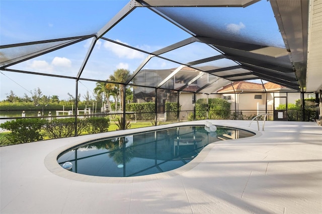 view of pool with a lanai, a patio area, and a water view