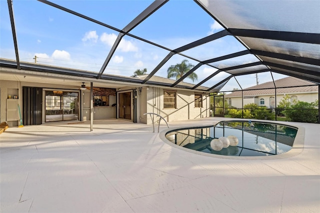 view of swimming pool featuring a lanai and a patio area