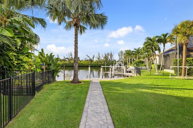 view of dock featuring a yard and a water view