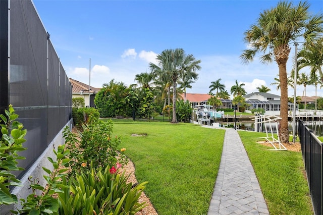 view of yard with a water view and a lanai