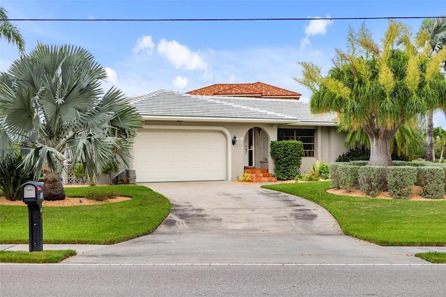 view of front of home featuring a front yard and a garage