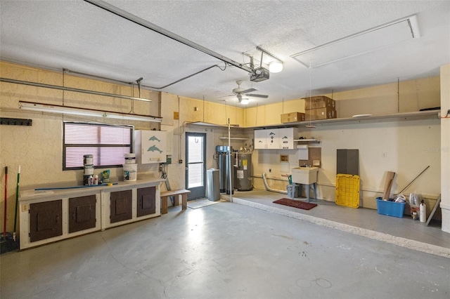 garage featuring a garage door opener, sink, and electric water heater