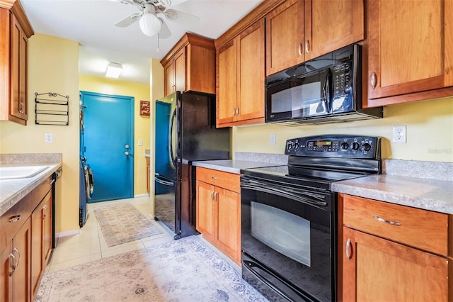 kitchen with black appliances, ceiling fan, sink, and light tile patterned flooring