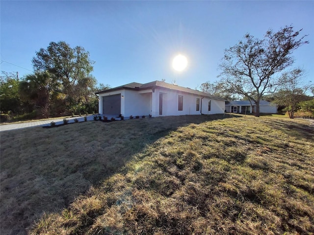 view of home's exterior featuring a garage and a yard