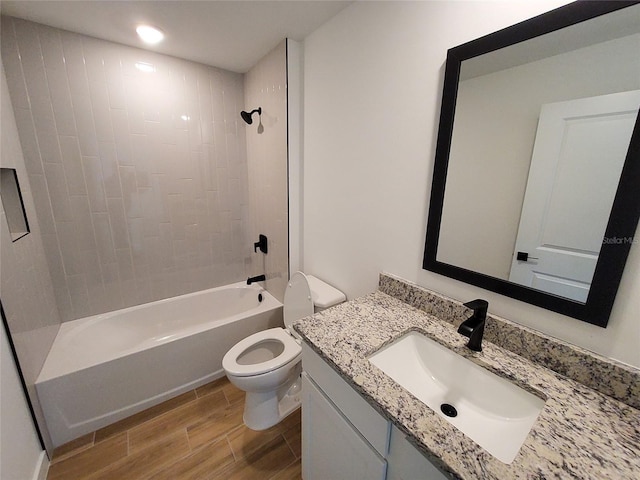 full bathroom featuring vanity, toilet, and tiled shower / bath