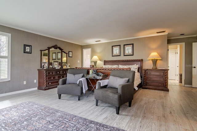 bedroom featuring crown molding and light hardwood / wood-style floors