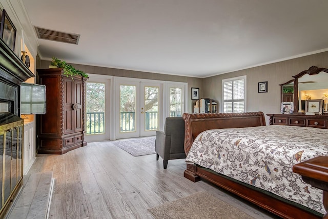 bedroom featuring crown molding, access to outside, and light hardwood / wood-style flooring