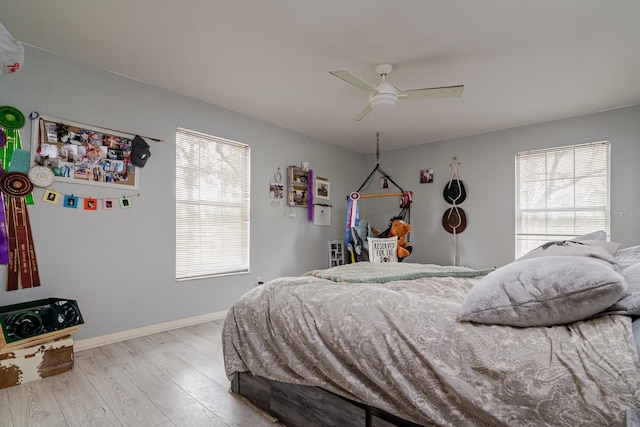 bedroom with ceiling fan and light hardwood / wood-style floors