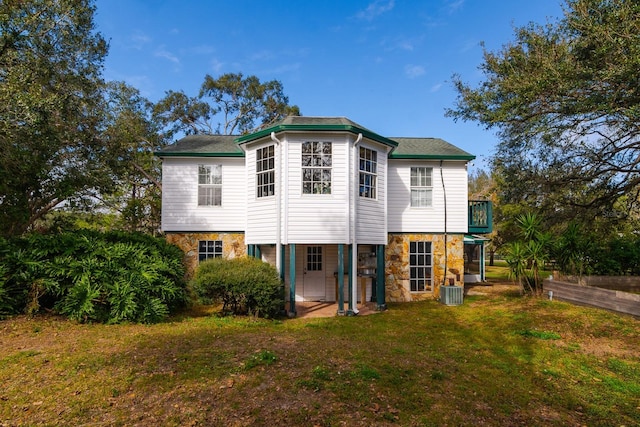 back of property featuring a yard and central air condition unit