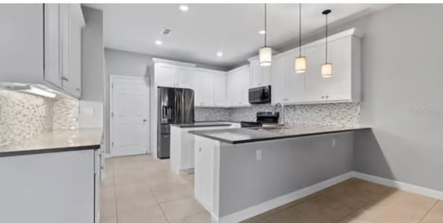 kitchen with appliances with stainless steel finishes, white cabinetry, backsplash, hanging light fixtures, and kitchen peninsula