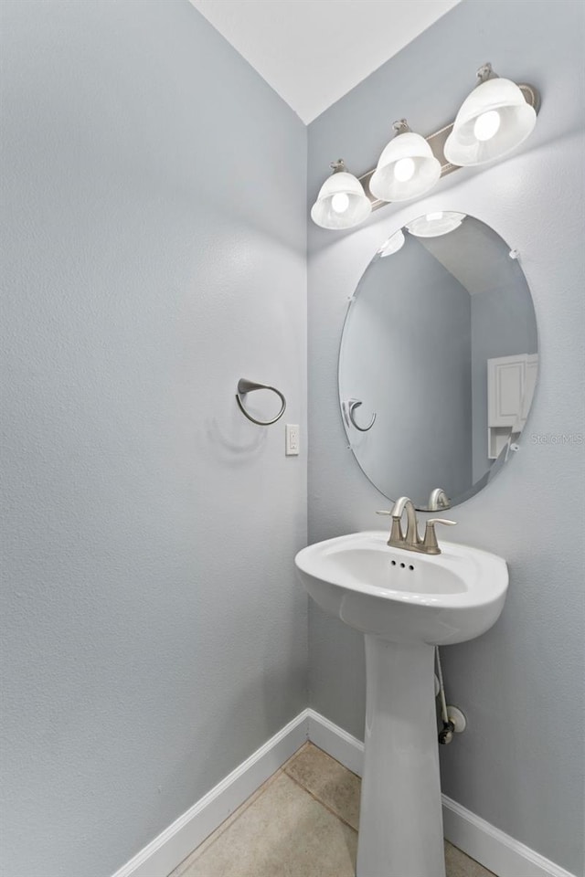 bathroom featuring tile patterned flooring and baseboards