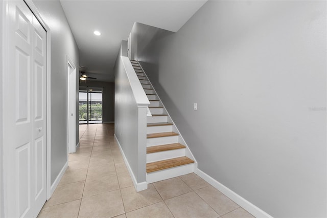 stairs with a ceiling fan, recessed lighting, baseboards, and tile patterned floors