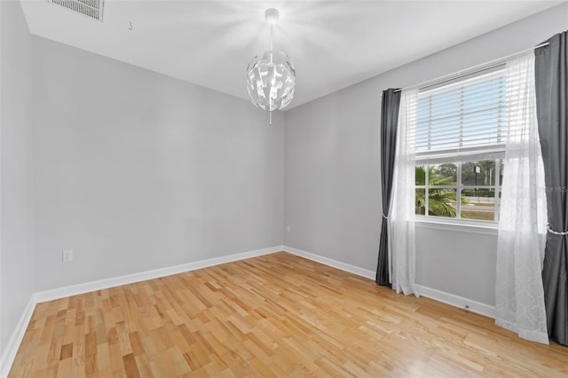 unfurnished room with baseboards, visible vents, and light wood finished floors